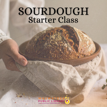 Loaf of sourdough held in flour sack towel
